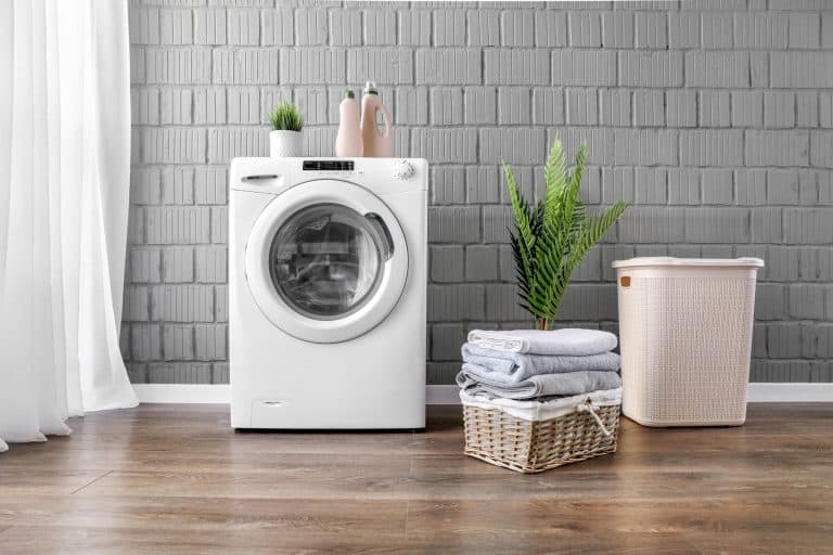 Clothes washing machine in laundry room interior with window. - 17 Curtain Ideas For The Laundry Room That You Should Try!